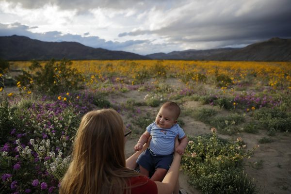 Mother holds her three-month-old son