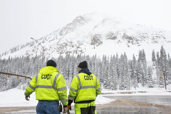 Transportation officials discuss with each other
