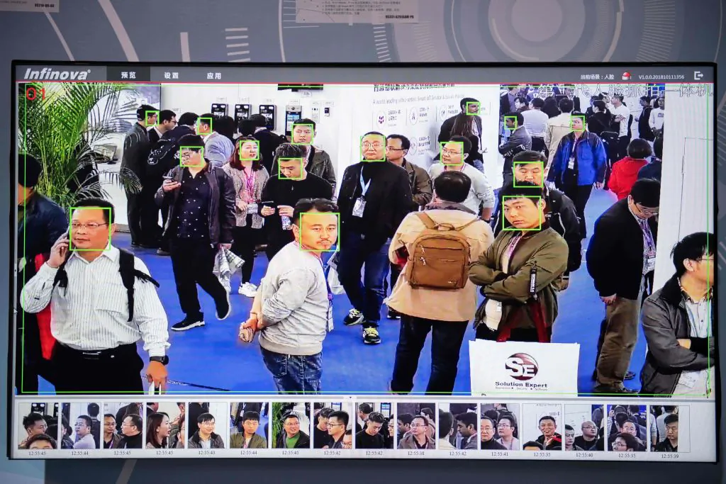 A screen shows visitors being filmed by AI (artificial intelligence) security cameras with facial recognition technology at the 14th China International Exhibition on Public Safety and Security at the China International Exhibition Center in Beijing on October 24, 2018. (NICOLAS ASFOURI/AFP/Getty Images)