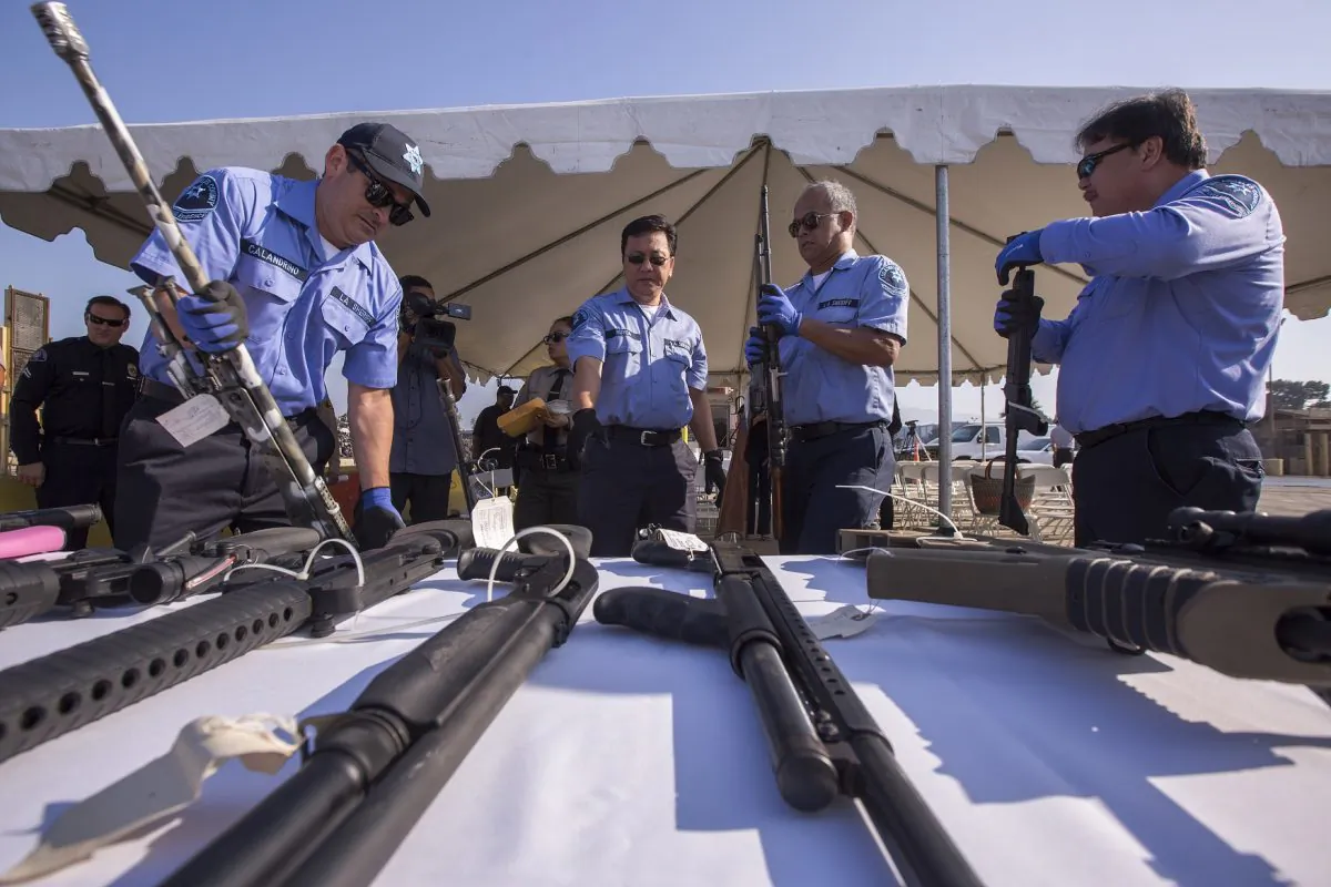 Deputies handle some of approximately 3,500 confiscated guns to be melted down at Gerdau Steel Mill in Rancho Cucamonga, Calif., on July 19, 2018. (David McNew/Getty Images)