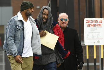 Singer R. Kelly center, walks with his attorney Steve Greenberg