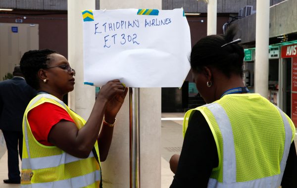 airport workers hang sign