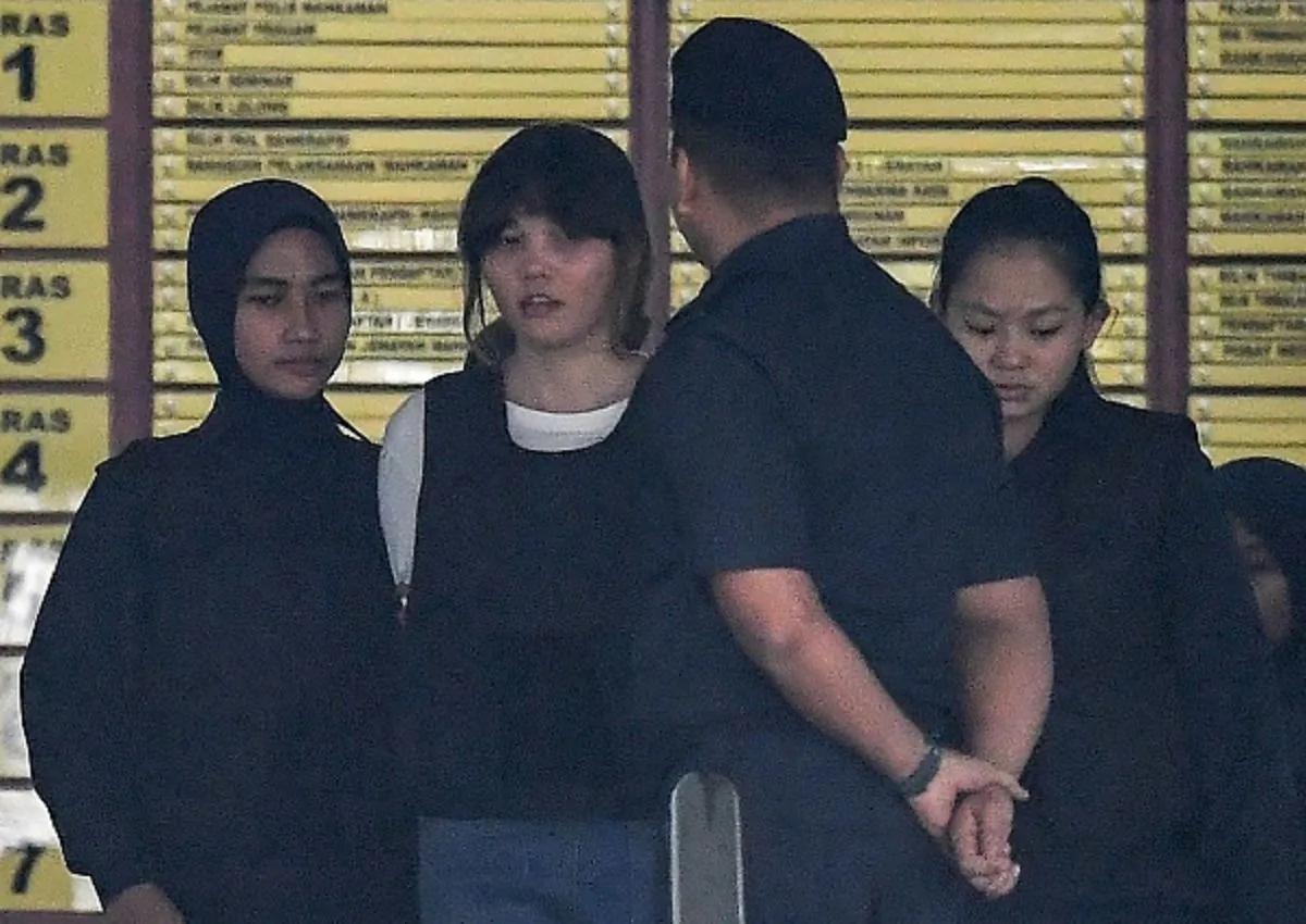 Royal Malaysian Police escort Vietnamese defendant Doan Thi Huong (2nd L) after her trial at the Shah Alam High Court in Shah Alam, outside Kuala Lumpur on Oct. 2, 2017, for her alleged role in the assassination of Kim Jong-Nam, the half-brother of North Korean leader Kim Jong. (Mohd Rasfan/AFP/Getty Images)
