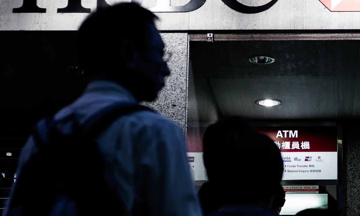 People line up at an ATM machine of an HSBC branch in Hong Kong on July 30, 2012.  (Philippe Lopez/AFP/GettyImage)