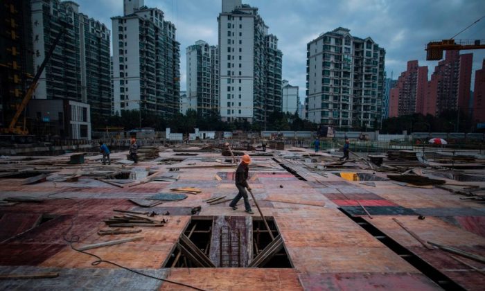 A man works at a construction site of a residential skyscraper in Shanghai. (JOHANNES EISELE/AFP/Getty Images)