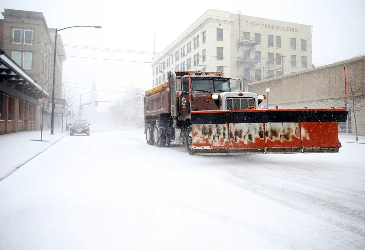 A snow plow rumbles north on Capitol Avenue during a blizzard in Casper, Wyo., on March 13, 2019. (Jacob Byk/The Wyoming Tribune Eagle via AP)