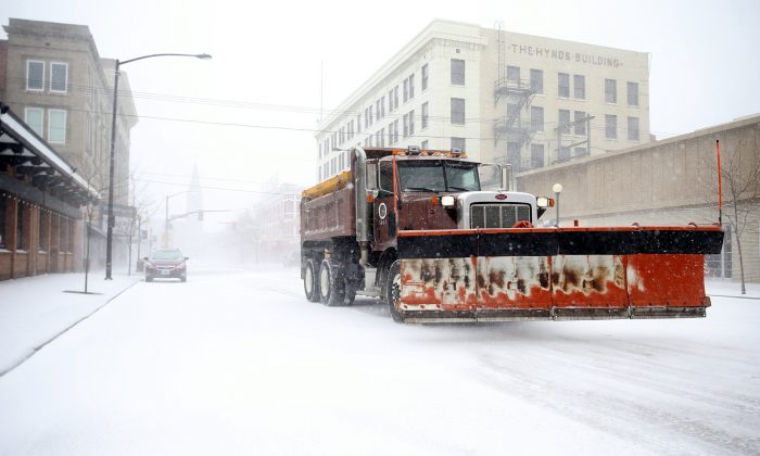 A snow plow rumbles north on Capitol Avenue during a blizzard on March 13, 2019, in Cheyenne, Wyo. (Jacob Byk/The Wyoming Tribune Eagle via AP)