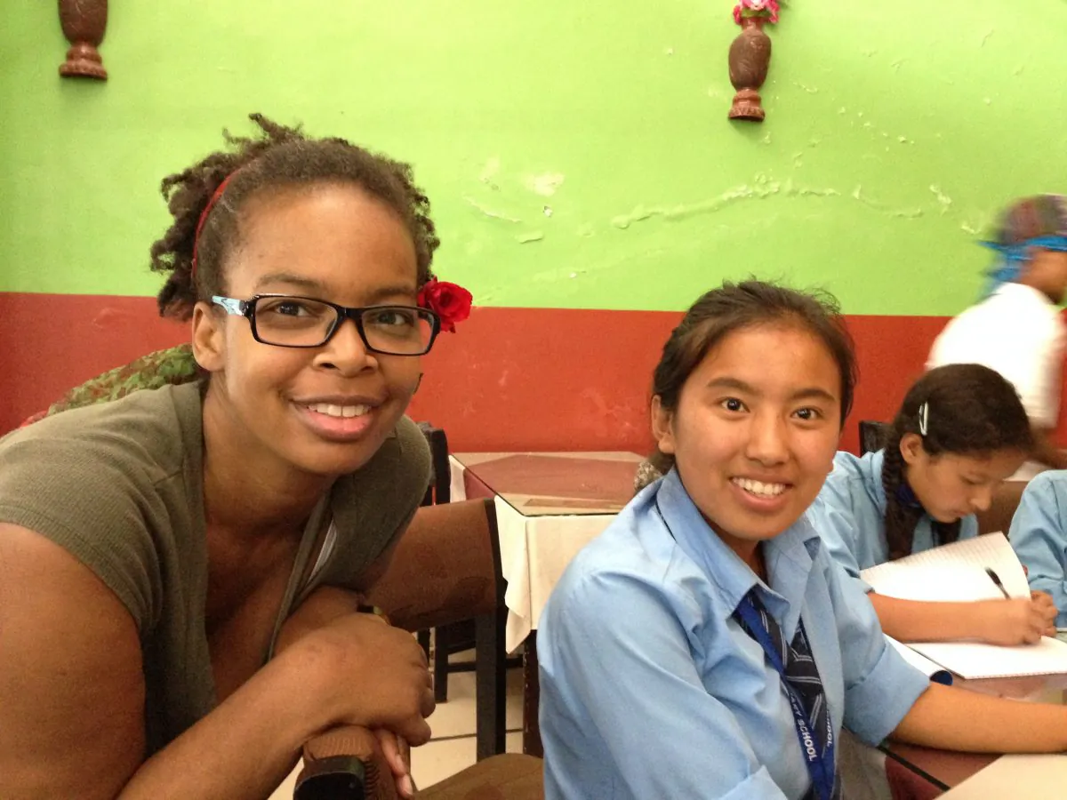Katerina Canyon (L) volunteering with a student in Nepal. (Courtesy of Katerina Canyon)