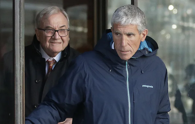 William "Rick" Singer, front, founder of the Edge College & Career Network, exits federal court in Boston on  March 12, 2019. (AP Photo/Steven Senne)