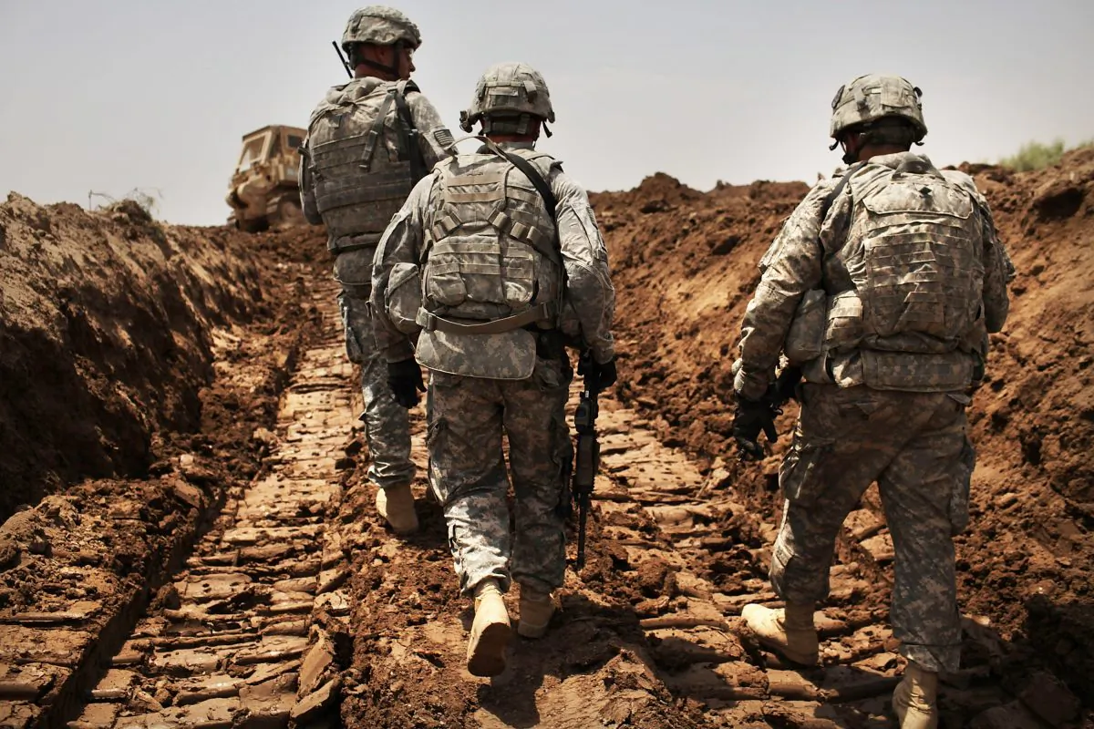 U.S. soldiers with the 3rd Armored Cavalry Regiment patrol a new ditch they have dug to protect the base from attack in Iskandariya, Babil Province, Iraq, on July 19, 2011. (Spencer Platt/Getty Images)