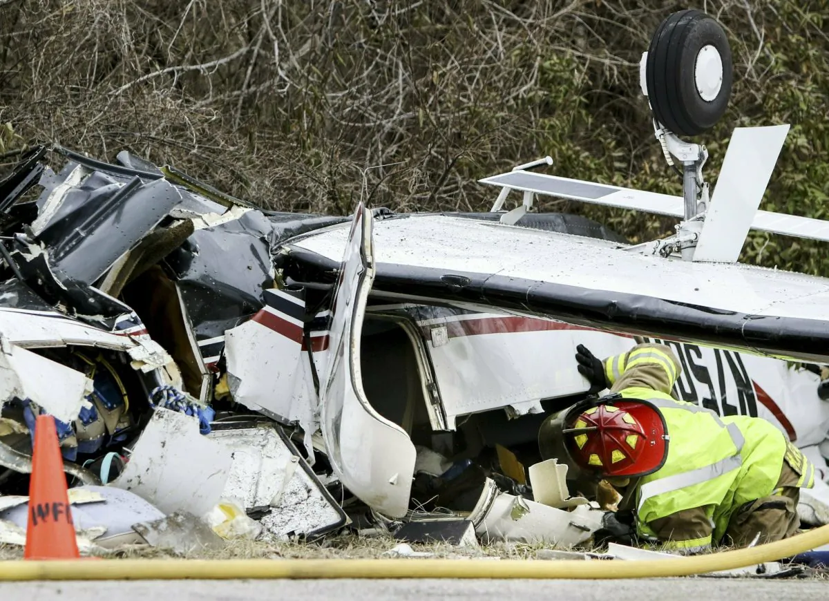 A firefighter checks the inside of a small single engine plane that crashed on March 12, 2019. (Colter Peterson/St. Louis Post-Dispatch via AP)