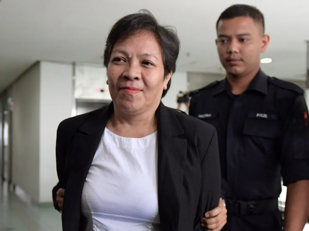 Maria Elvira Pinto Exposto (L), 54, is escorted upon her arrival at the Shah Alam High Court ahead of the verdict in her drugs conviction in Shah Alam, outside Kuala Lumpur, on Dec. 27, 2017.
(Mohd Rasfan/AFP/Getty Images)