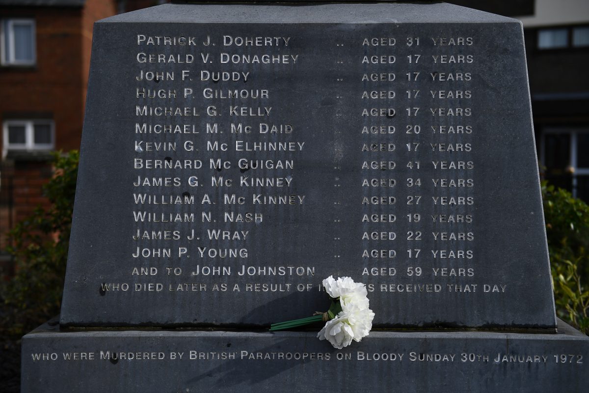 Flowers are left at the memorial for the people who died during the Bloody Sunday events