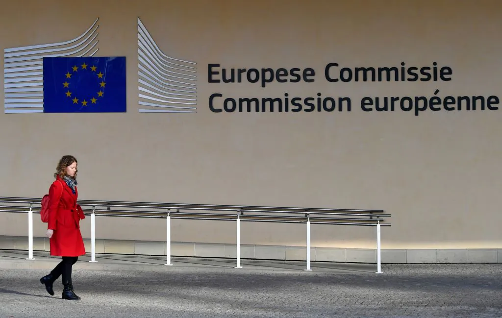 A woman walks past the entrance of the European Commission in Brussels on Nov. 14, 2018. (Emmanuel Dunand/AFP/Getty Images)