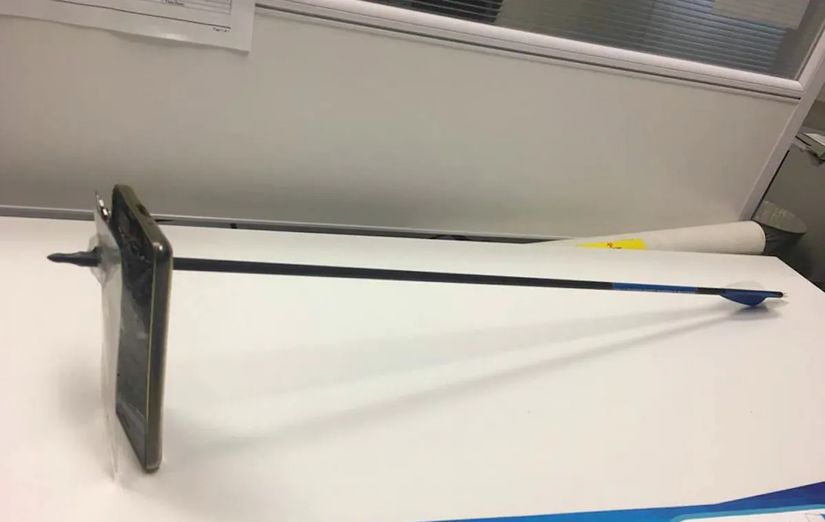 A mobile phone with an arrow embedded in it in the town of Nambin, New South Wales, Australia. (New South Wales Police)