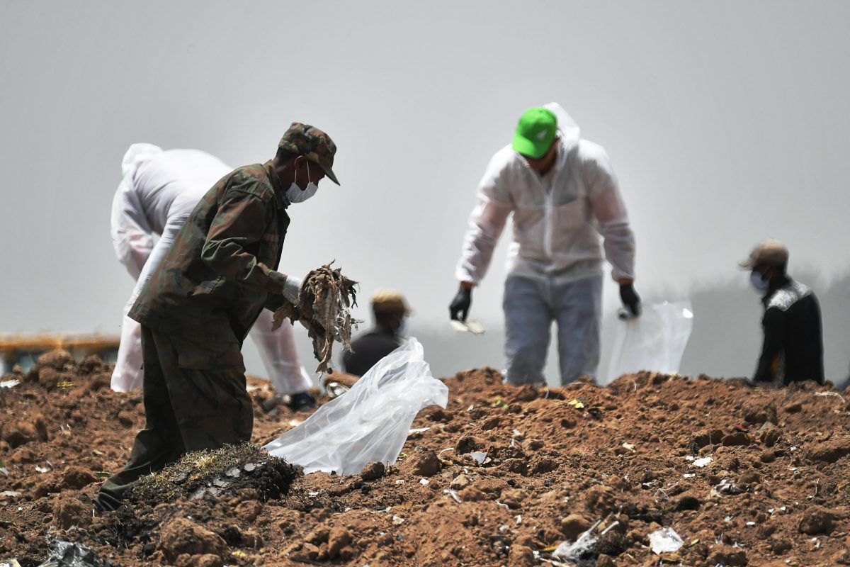 Forensics experts comb through the dirt for debris