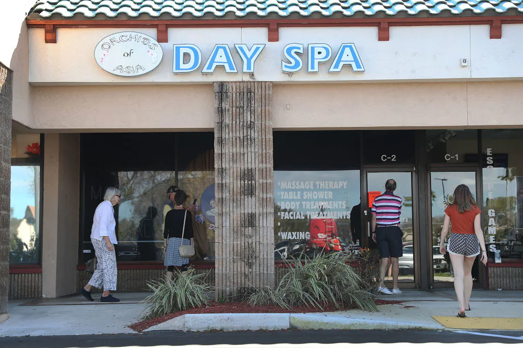 People mill around in front of the Orchids of Asia Day Spa in Jupiter, Florida, on Feb. 22, 2019. The former owner of the spa was recently revealed to have sought out opportunities to network with Republican Party politicians. (Joe Raedle/Getty Images)
