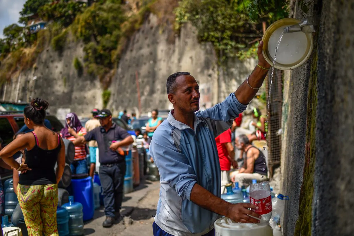 A man fills containers with water flowing down from the Wuaraira Repano mountain, also called "El Avila", in Caracas on March 13, 2019. Millions in Venezuela have been left without running water.(Federico Parra/AFP/Getty Images)