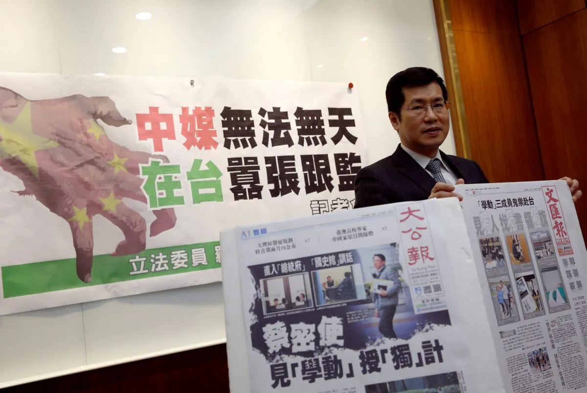 Democratic Progressive Party lawmaker Lo Chih Cheng poses with copies of Hong Kong's Ta Kung Pao and Wen Wei Po newspapers after a news conference in Taipei, Taiwan on Jan. 18, 2019. (Tyrone Siu/Reuters)
