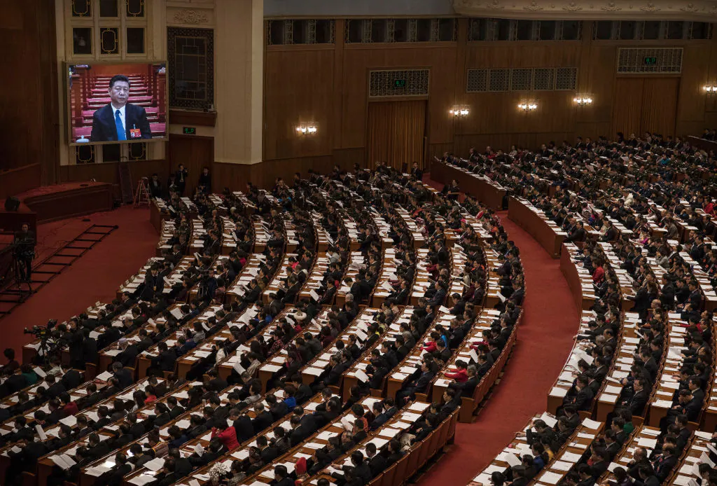 Chinese President Xi Jinping is seen on a screen as delegates look on during the third plenary session of the National People's Congress at The Great Hall Of The People on March 12, 2019 in Beijing, China. The annual Two Sessions gathering of Communist Party officials and delegates lays out a road map for the governments year ahead, including economic growth targets, diplomacy and military spending. (Kevin Frayer/Getty Images)