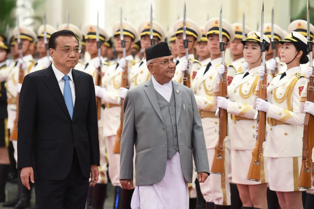 Nepal's Prime Minister K.P. Sharma Oli reviews a military honour guard with Chinese Premier Li Keqiang during a welcome ceremony at the Great Hall of the People in Beijing on June 21, 2018. (Greg Baker/AFP/Getty Images)