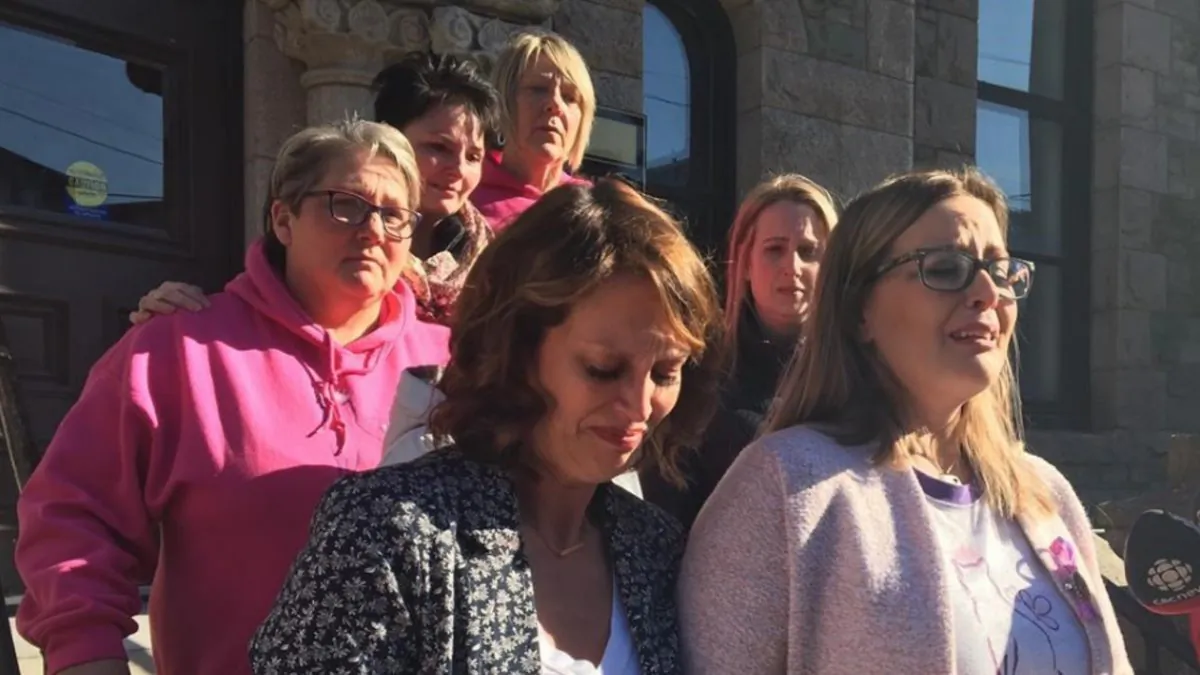 Andrea Gosse (right) leaves a St. John's, N.L. courthouse, on March 15, 2019, surrounded with supporters shortly after hearing the first-degree murder conviction of Trent Butt, found guilty of killing their five-year-old daughter Quinn almost three years ago. (Holly McKenzie-Sutter/The Canadian Press)