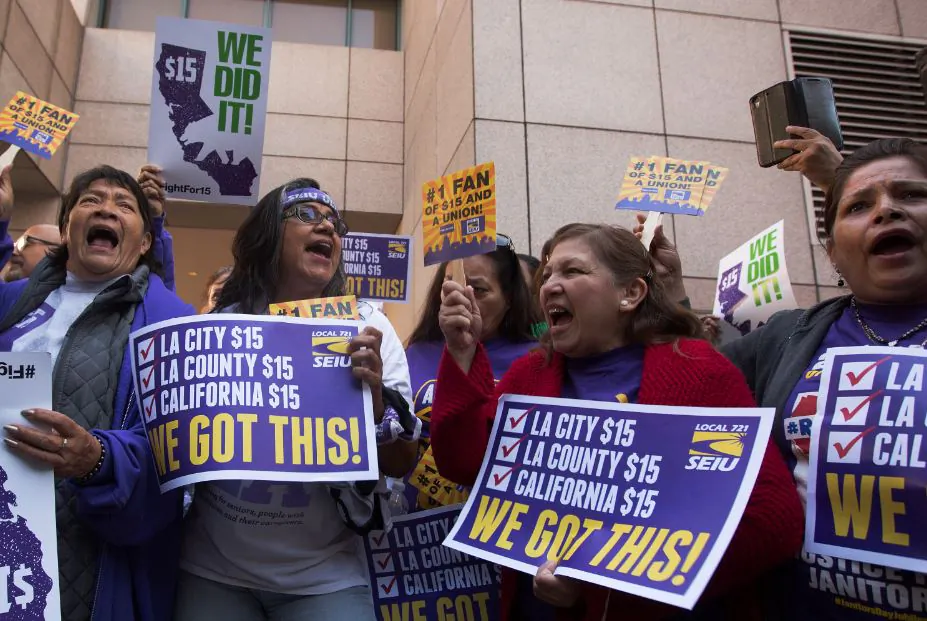 Service Employees International Union members celebrate after California Governor Jerry Brown signed landmark legislation SB 3 into law in Los Angeles, Calif. on April 4, 2016. (David McNew/Getty Images)