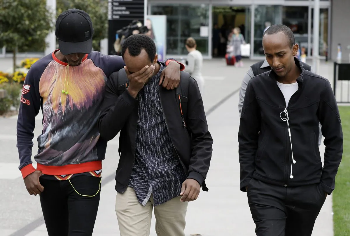 Abdifatah Ibrahim (C), and his brother Abdi (R), walk with an unidentified friend in Christchurch, New Zealand, on March 17, 2019, their 3-year-old brother Mucaad the youngest victim. (Mark Baker via AP)