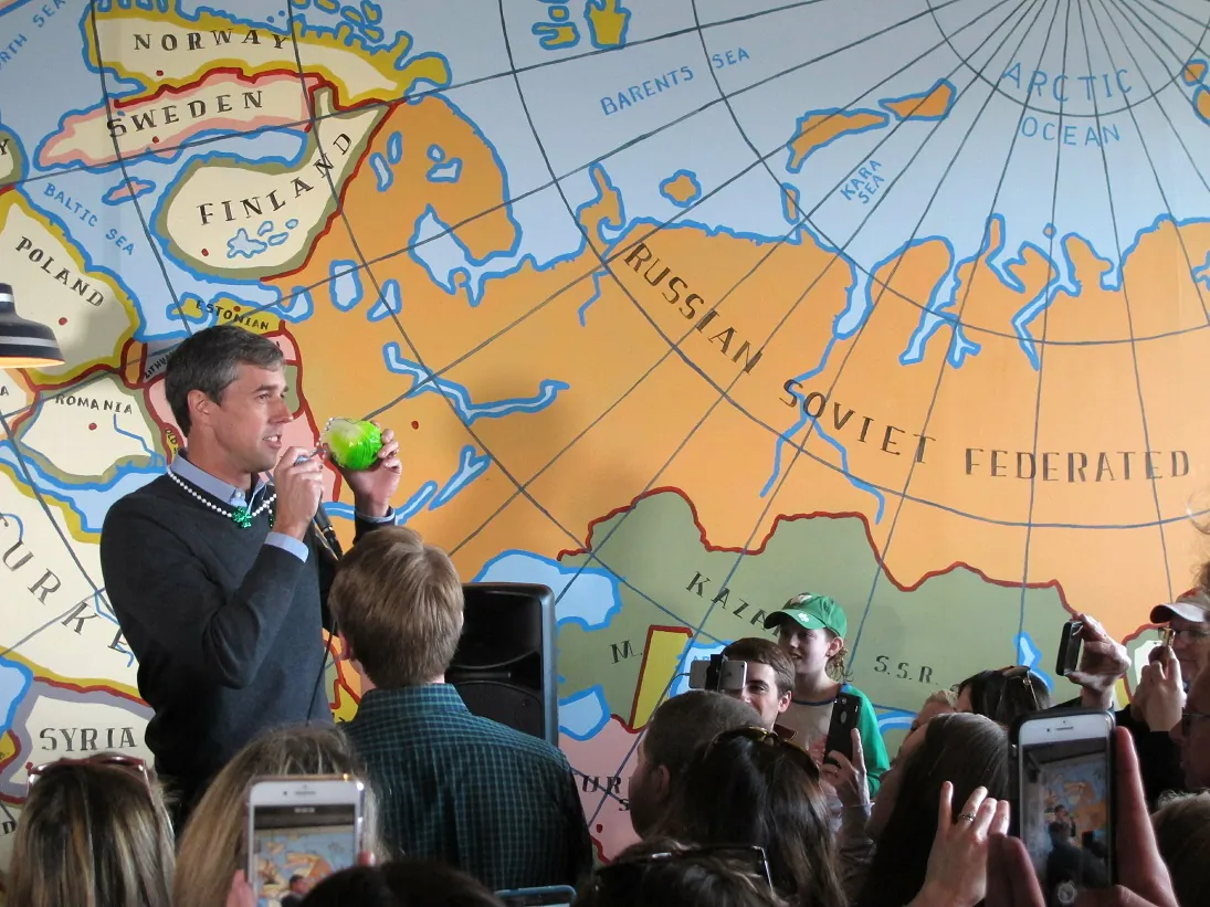 Democratic presidential candidate Beto O'Rourke speaks to supporters at a coffee shop in Madison, Wisconsin on March 17, 2019. O'Rourke came in wearing a green cabbage St. Patrick's Day necklace given to him by a supporter during breakfast. (AP Photo/Scott Bauer)