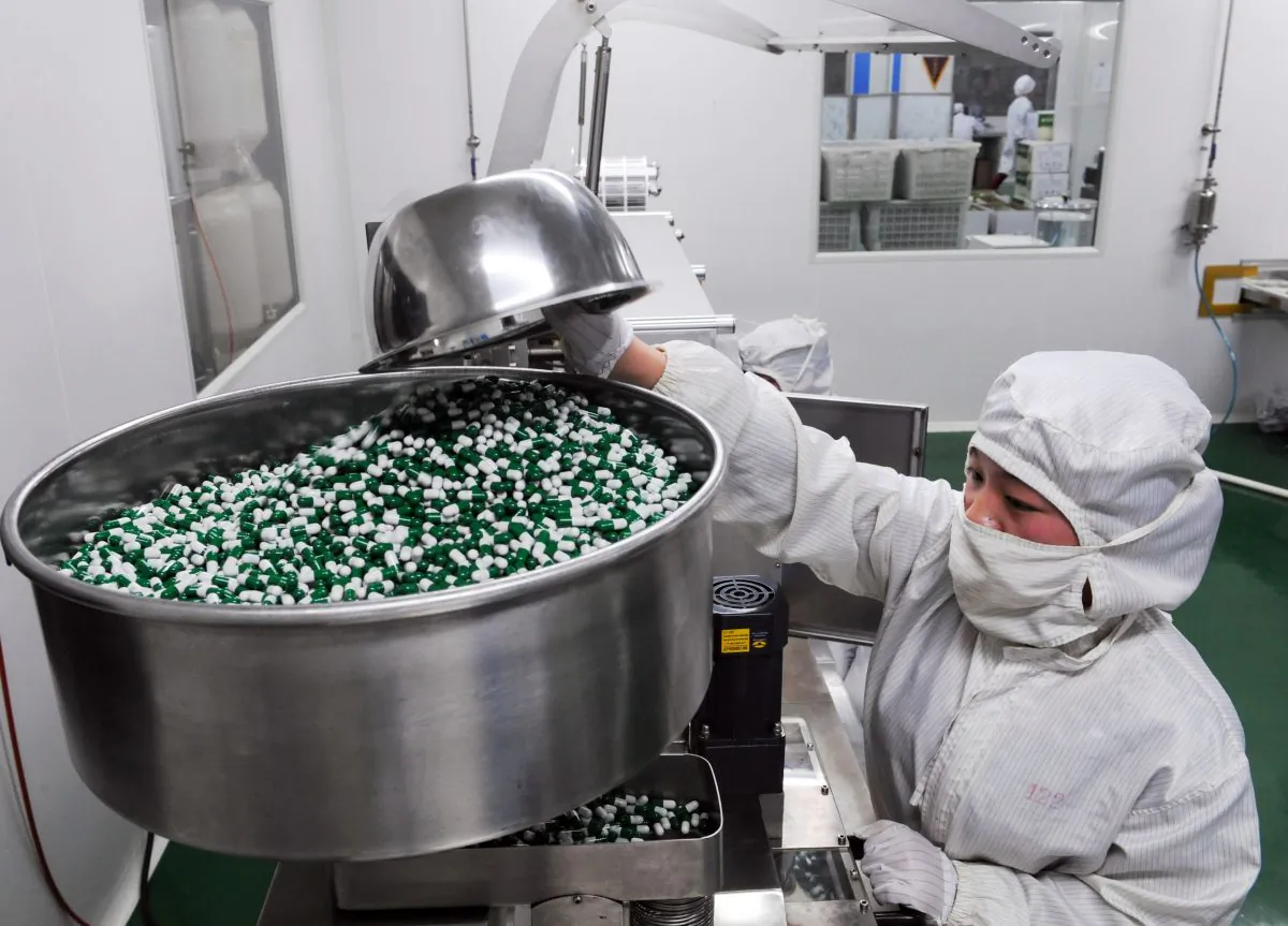 Employees work on the production line of an herbal medicine company in Bozhou, Anhui Province, China, on April 8, 2013. (VCG via Getty Images)