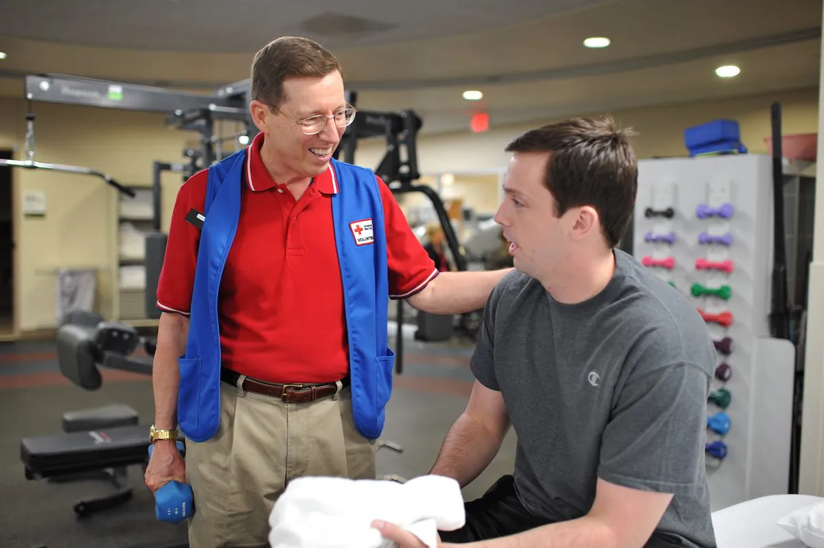 Stephen Peth (L) working with an amputee at the Military Advanced Training Center. (Courtesy of the American Red Cross)