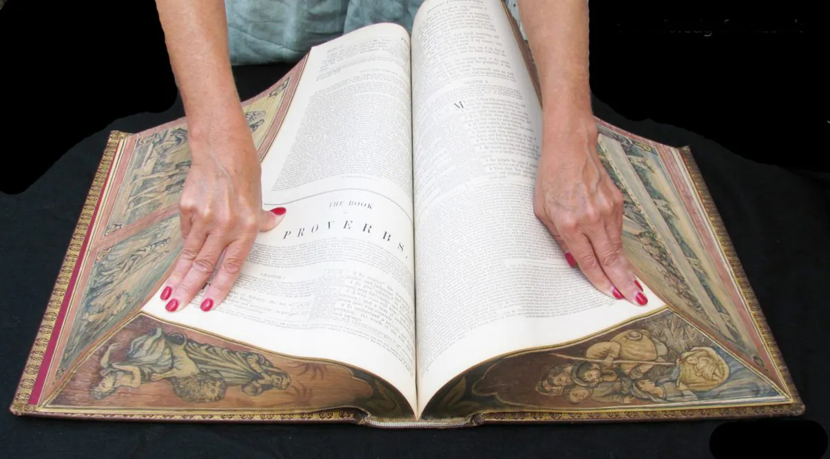 Vanishing fore-edge paintings are on all the edges of this family Bible; the images are revealed when the book is twisted, as in this photo. (Foredgefrost)
