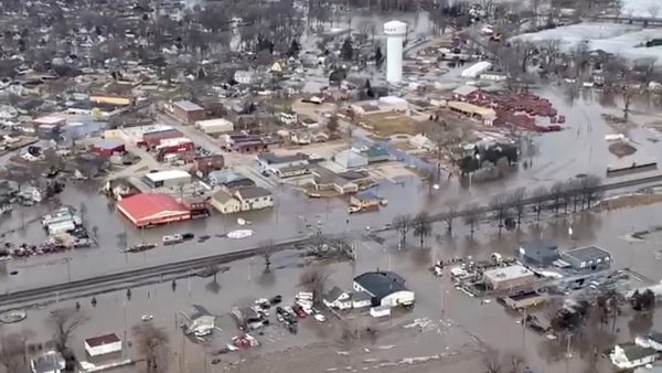 An aerial view of damaged buildings after a storm triggered historic flooding,