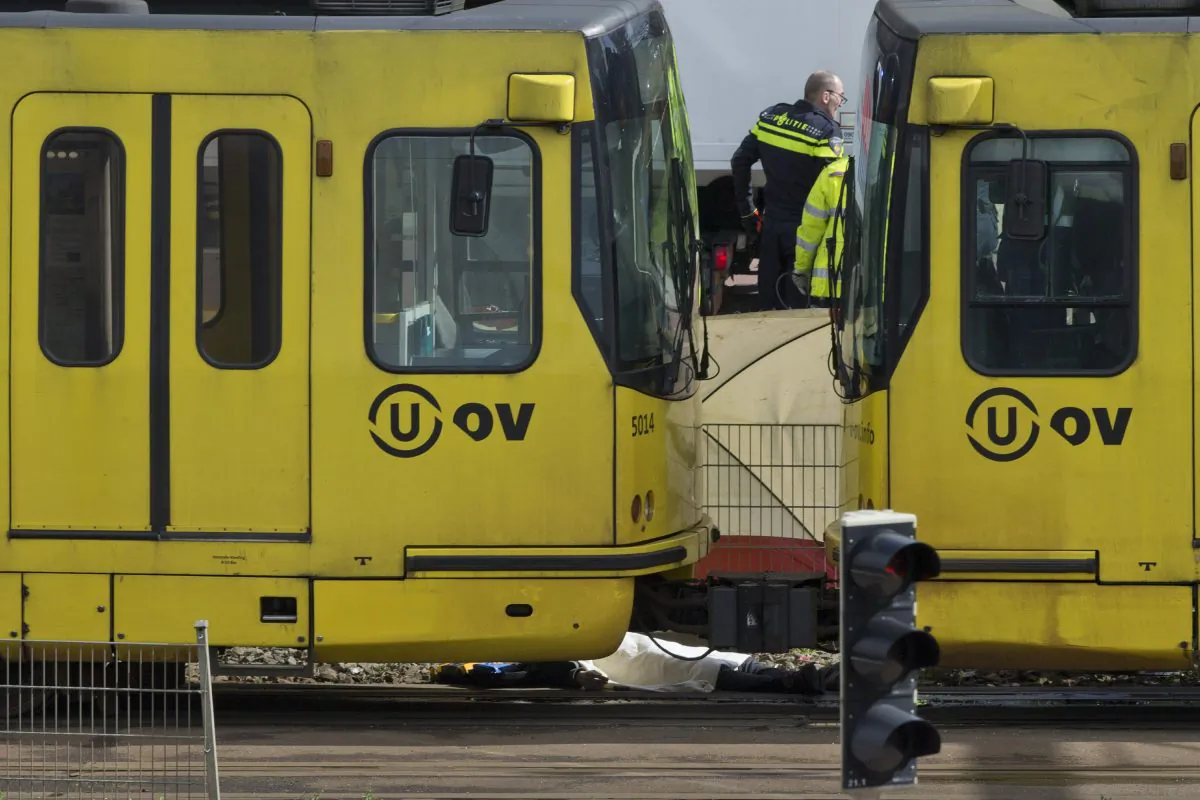 A body is covered with a white sheet after a shooting in a tram in Utrecht, Netherlands, Monday, March 18, 2019. (AP Photo/Peter Dejong)