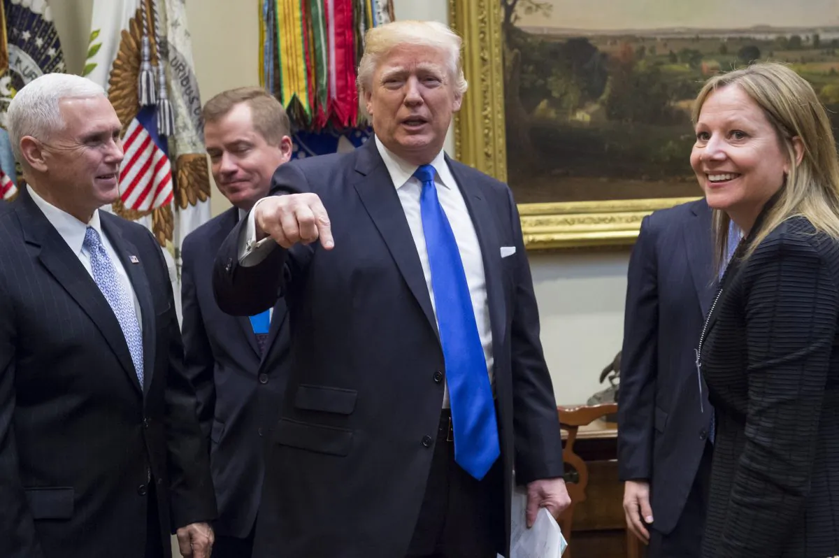 President Donald Trump greets General Motors CEO Mary Barra (R) alongside US Vice President Mike Pence (L) prior to a meeting with automobile industry leaders in the Roosevelt Room of the White House in Washington on Jan. 24, 2017. (Saul Loeb/AFP/Getty Images)