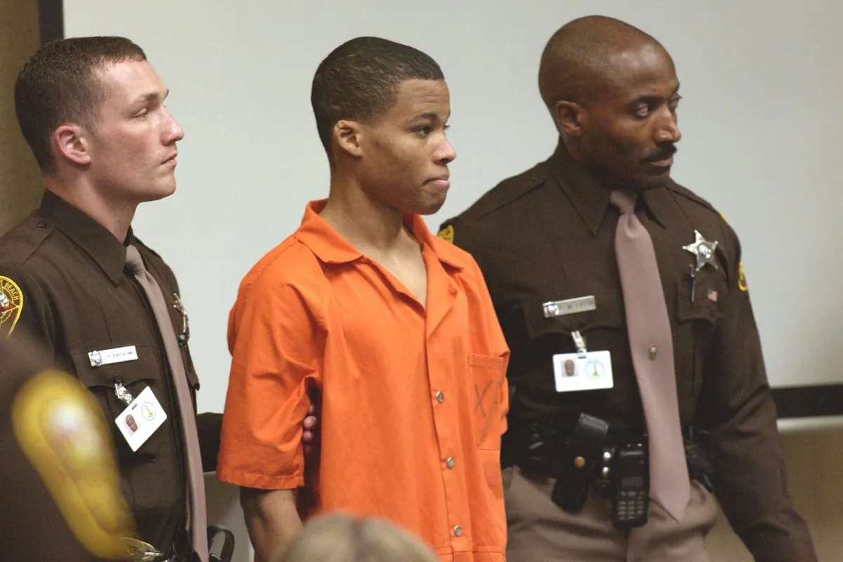 Sniper suspect Lee Boyd Malvo (C) is escorted by deputies as he is brought into court to be identified by a witness during the murder trial in courtroom 10 at the Virginia Beach Circuit Court in Virginia Beach, Virginia on Oct. 22, 2003. (Davis Turner-Pool/Getty Images)