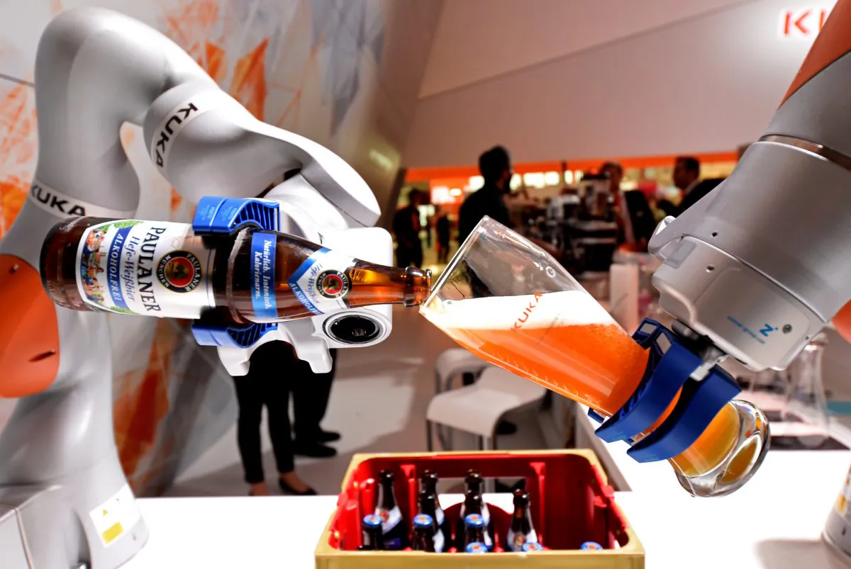 A robotic arm fills a glass with Bavarian Weiss beer at the booth of German company Kuka at the world's biggest industrial fair, "Hannover Fair," in Hanover, Germany on April 24, 2017. (Fabian Bimmer/Reuters)