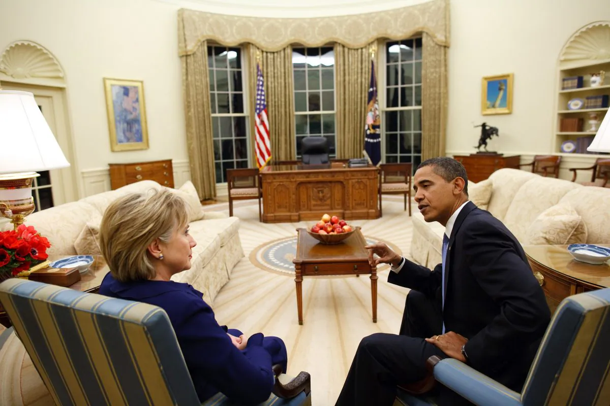Then-President Barack Obama talks with his Secretary of State Hillary Rodham Clinton in the Oval Office of the White House on January 21, 2009. (Pete Souza/White House via Getty Images)