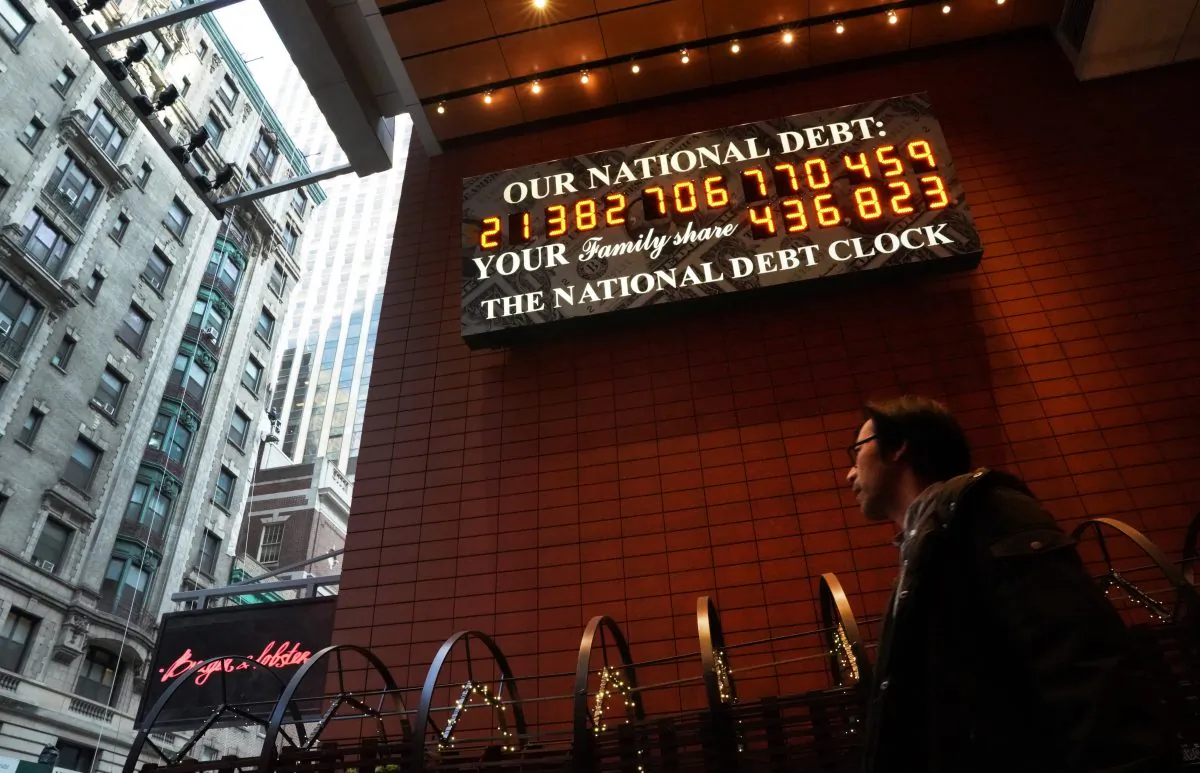 A man walks past the he National Debt Clock on 43rd Street in midtown New York City Feb. 15, 2019. (TIMOTHY A. CLARY/AFP/Getty Images)
