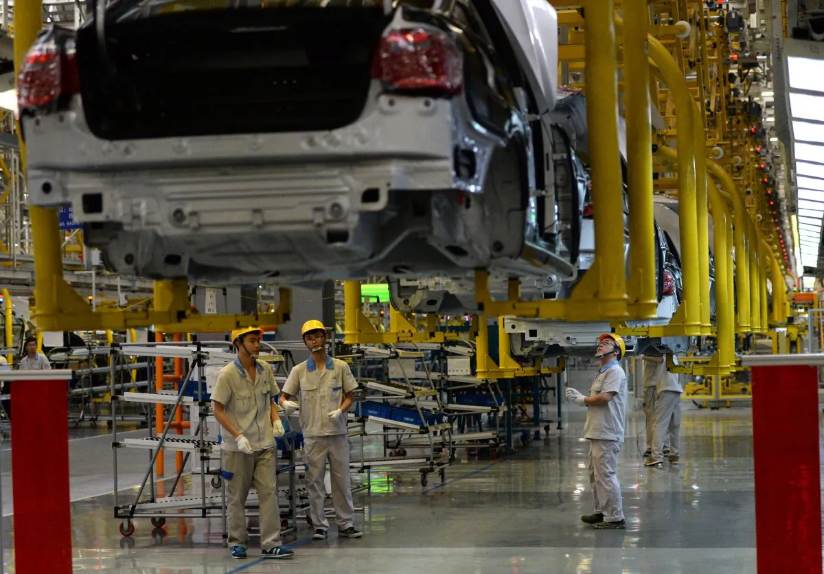 Chinese auto workers on the assembly line at the FAW-Volkswagen plant in Chengdu City, in southwestern China's Sichuan Province, on July 6, 2014. (GOH CHAI HIN/AFP/Getty Images)