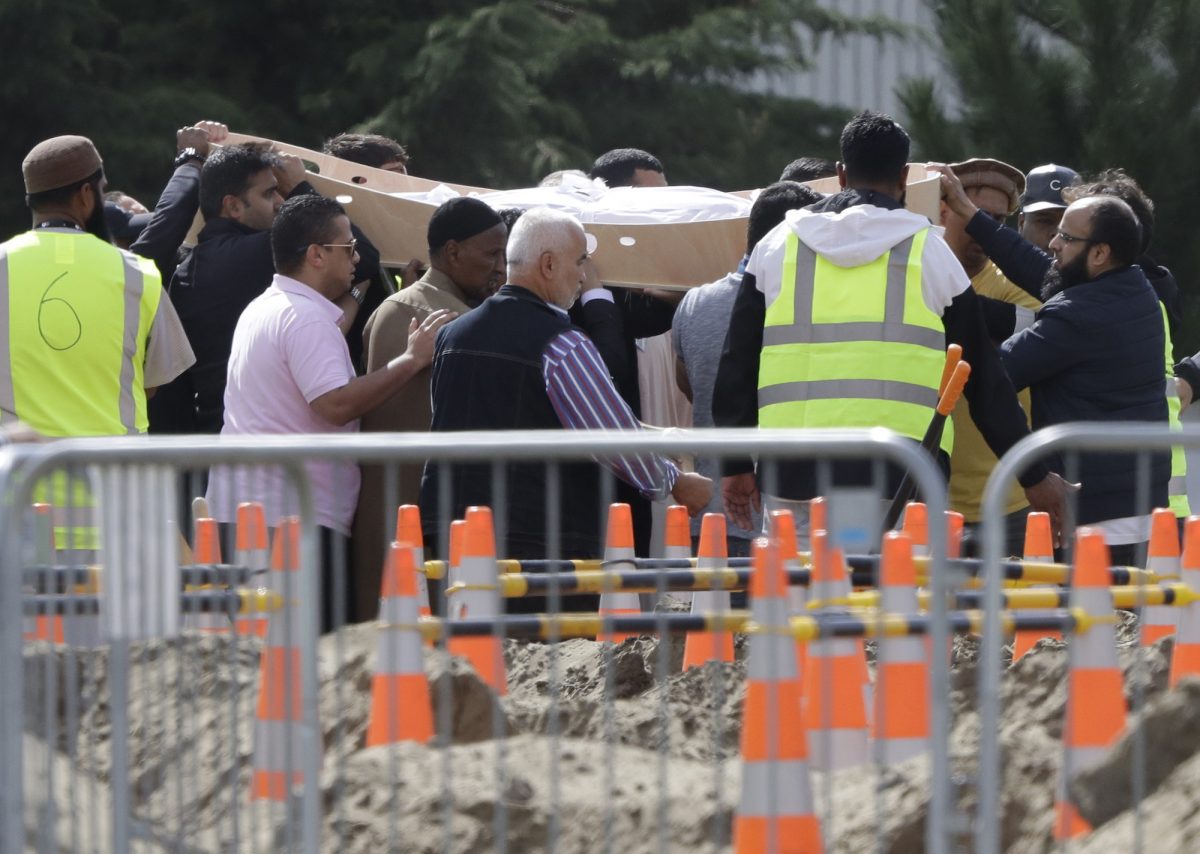Mourners carry coffins