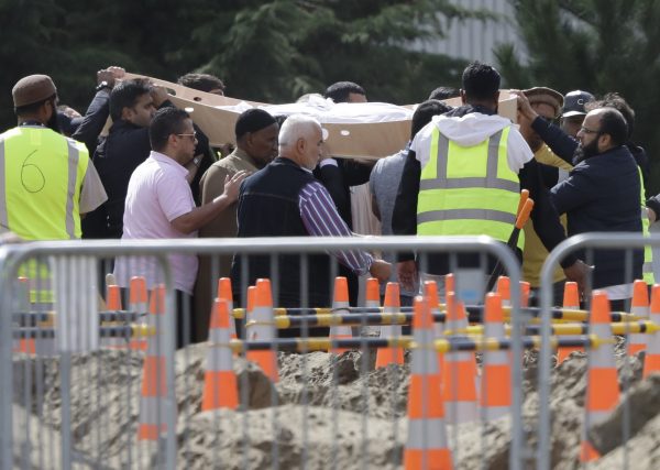 Mourners carry coffins