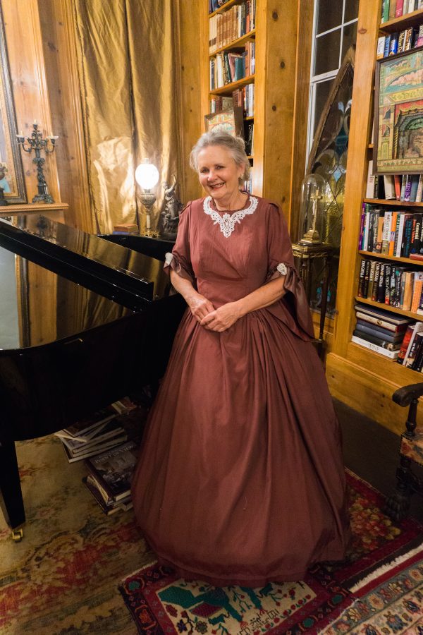 Colleen Wilkins in front of piano at Sunnyside Bed and Breakfast