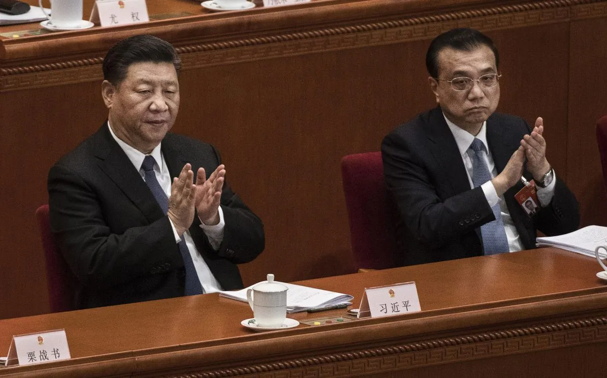 Chinese leader Xi Jinping (L), and Premier Li Keqiang (R) applaud during the third plenary session of the National People's Congress at The Great Hall Of The People on March 12, 2019 in Beijing, China. Kevin Frayer/Getty Images