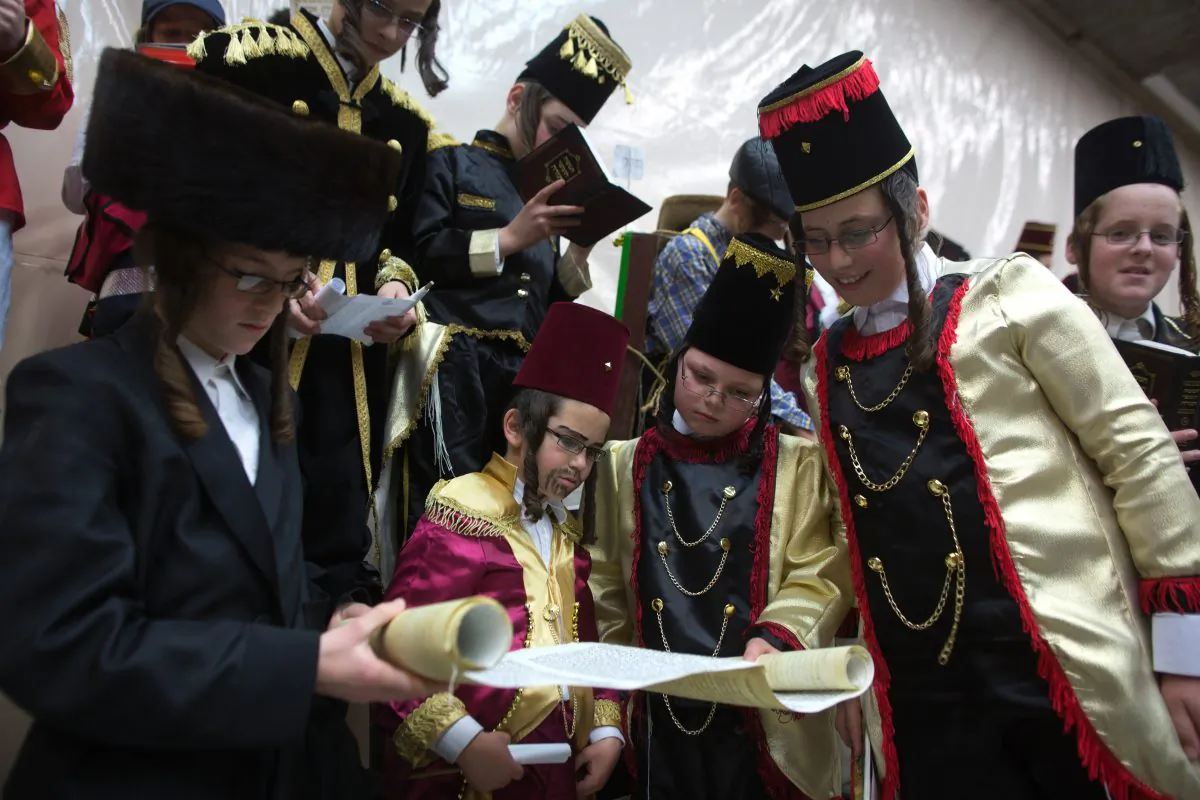Ultra-Orthodox Jewish boys wearing costumes read the book of Esther at a synagogue in the Israeli city of Bnei Brak near the costal city of Tel Aviv on March 4, 2015 during the feast of Purim. MENAHEM KAHANA/AFP/Getty Images