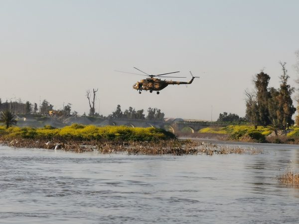 An Iraqi rescue helicopter searches for survivors at the site