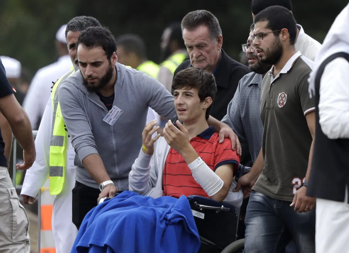 Zaed Mustafa, in wheelchair, brother of Hamza and son of Khalid Mustafa killed in the March 15 mosque shootings reacts during their burial at the Memorial Park Cemetery in Christchurch, New Zealand, on March 20, 2019. (Mark Baker/AP Photo)