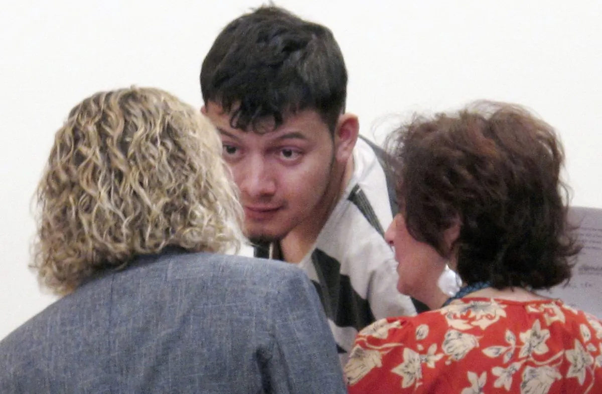Wilber Ernesto Martinez-Guzman, 19, of El Salvador, talks to his public defender and interpreter during his initial appearance in Carson City Justice Court in Carson City, Nev., on Jan. 24, 2019. (Scott Sonner/AP Photo)
