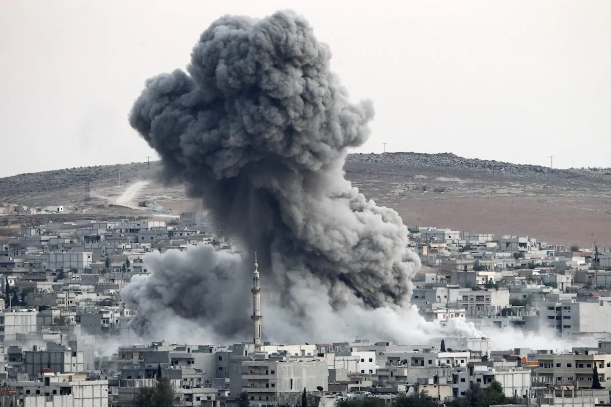 Heavy smoke rises following an airstrike by the US-led coalition aircraft in Kobani, Syria, during fighting between Syrian Kurds and the ISIS terrorists, as seen from the outskirts of Suruc, on the Turkey-Syria border, on Oct. 18, 2014. (Gokhan Sahin/Getty Images)