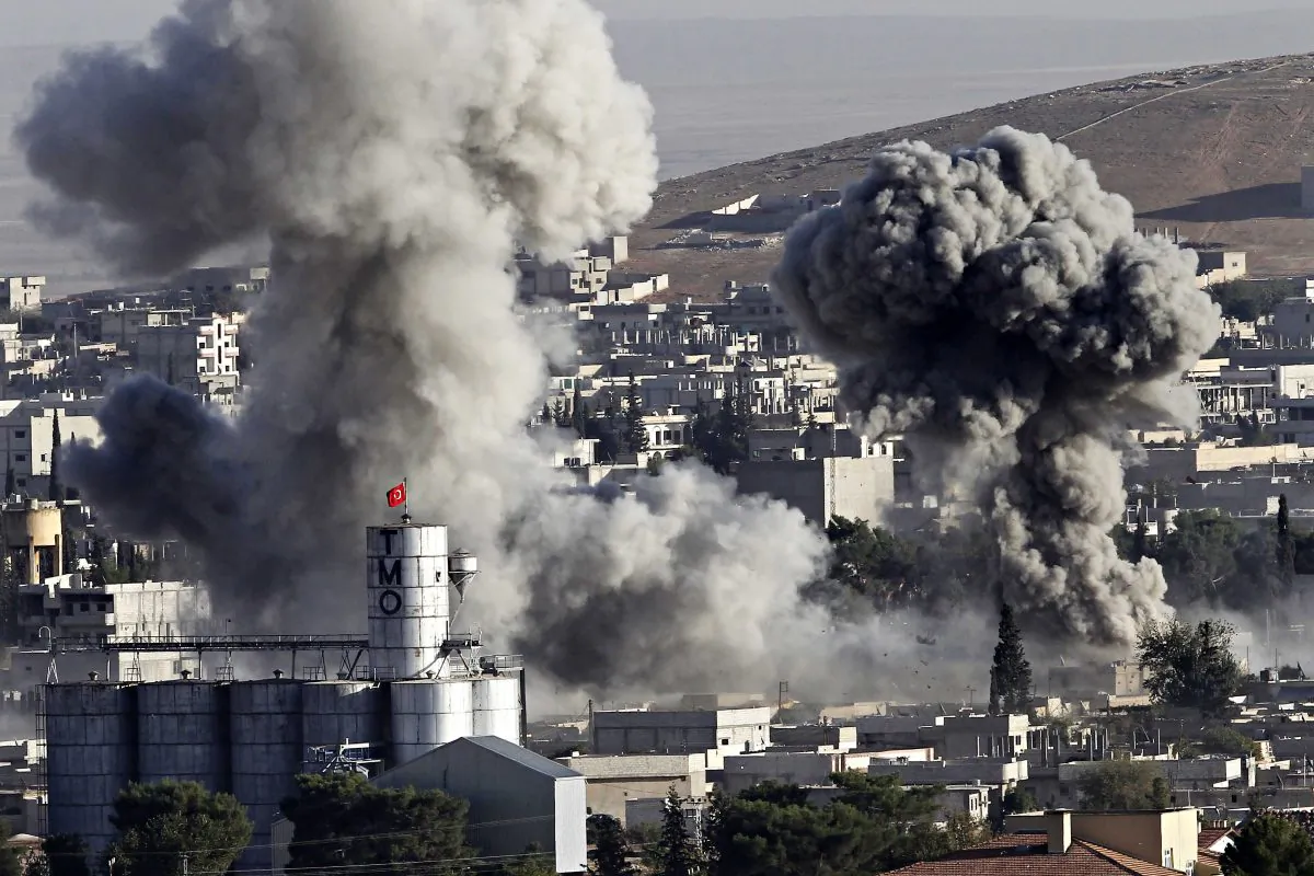 Heavy smoke from a fire caused by a strike rises in Kobani, Syria as fighting intensified between Syrian Kurds and the ISIS terrorists, as seen from Mursitpinar in the outskirts of Suruc, at the Turkey-Syria border, Oct. 10, 2014. (Gokhan Sahin/Getty Images)